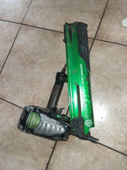 This is a Hitachi NR90AE framing nailer featuring a green body and black handle.