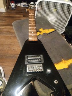 Very cool Mini flying v guitar pee wee vee works great needs strings only 45 bucks cash