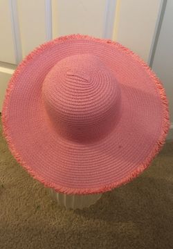Pink straw hat with fringe on the bottom