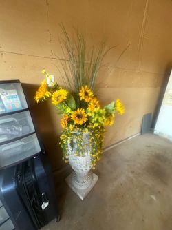 very large vase with sunflowers flowers
