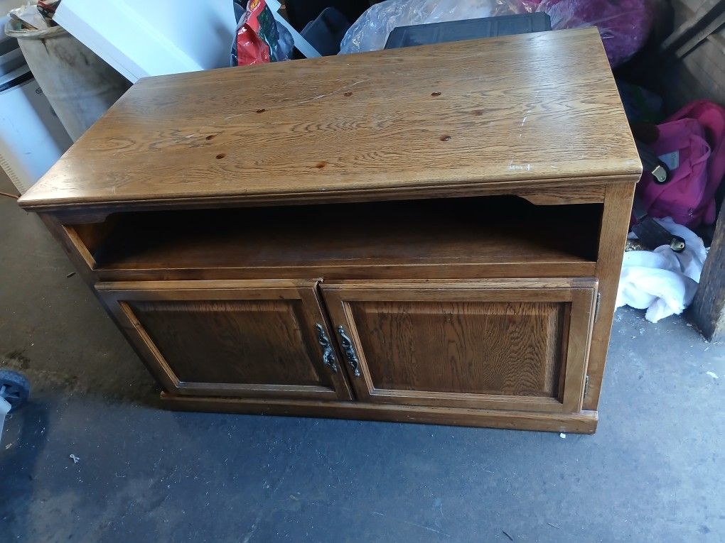 TV Stand That Has Doors That Open And Close For Extra Storage 
