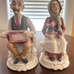 Bisque porcelain old man and woman marked 7 inch tall figurines