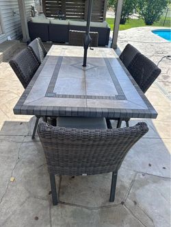 Outdoor dining table and umbrella