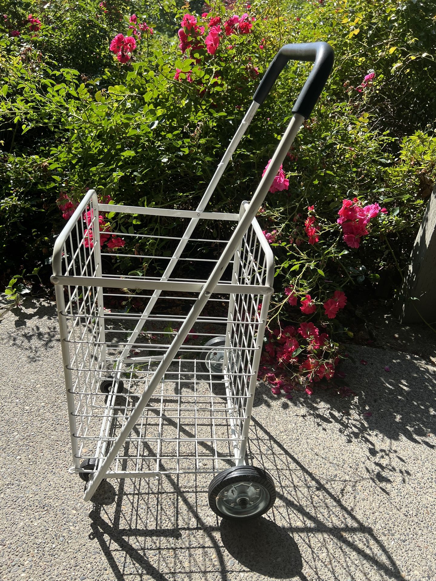 Folding shopping cart basket on wheels .
