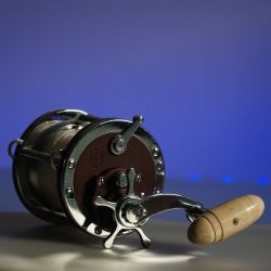 Penn senator 113h  handle is cream color with a custom heavy duty rod great for boat fishing 