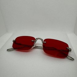 Metal rimless sunglasses with thickened lenses, a small metal frame stand, and metal hinges designed for street snap.