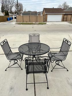 Wrought iron patio set, table 42 inch diameter , 4 bouncy chairs