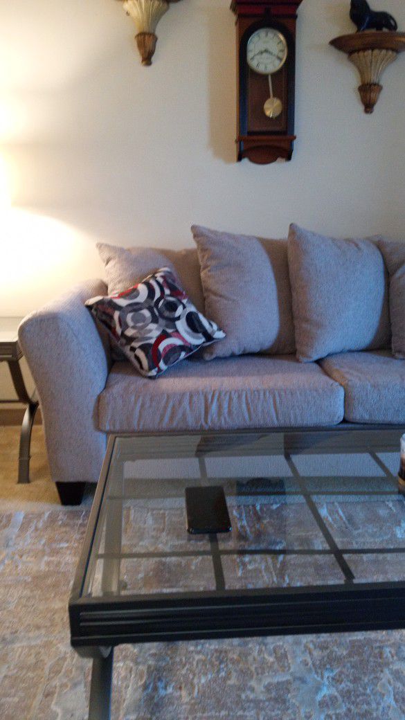 Grey Material Couch And Loveseat.  It's On The Light Side Of Grey.  I've Only Had It 2 Months But, I Cannot Fit My Wheel Chair With It. 