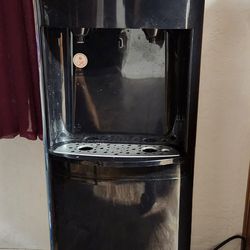 PRIMO water dispenser, bottom load with 2 water bottles.