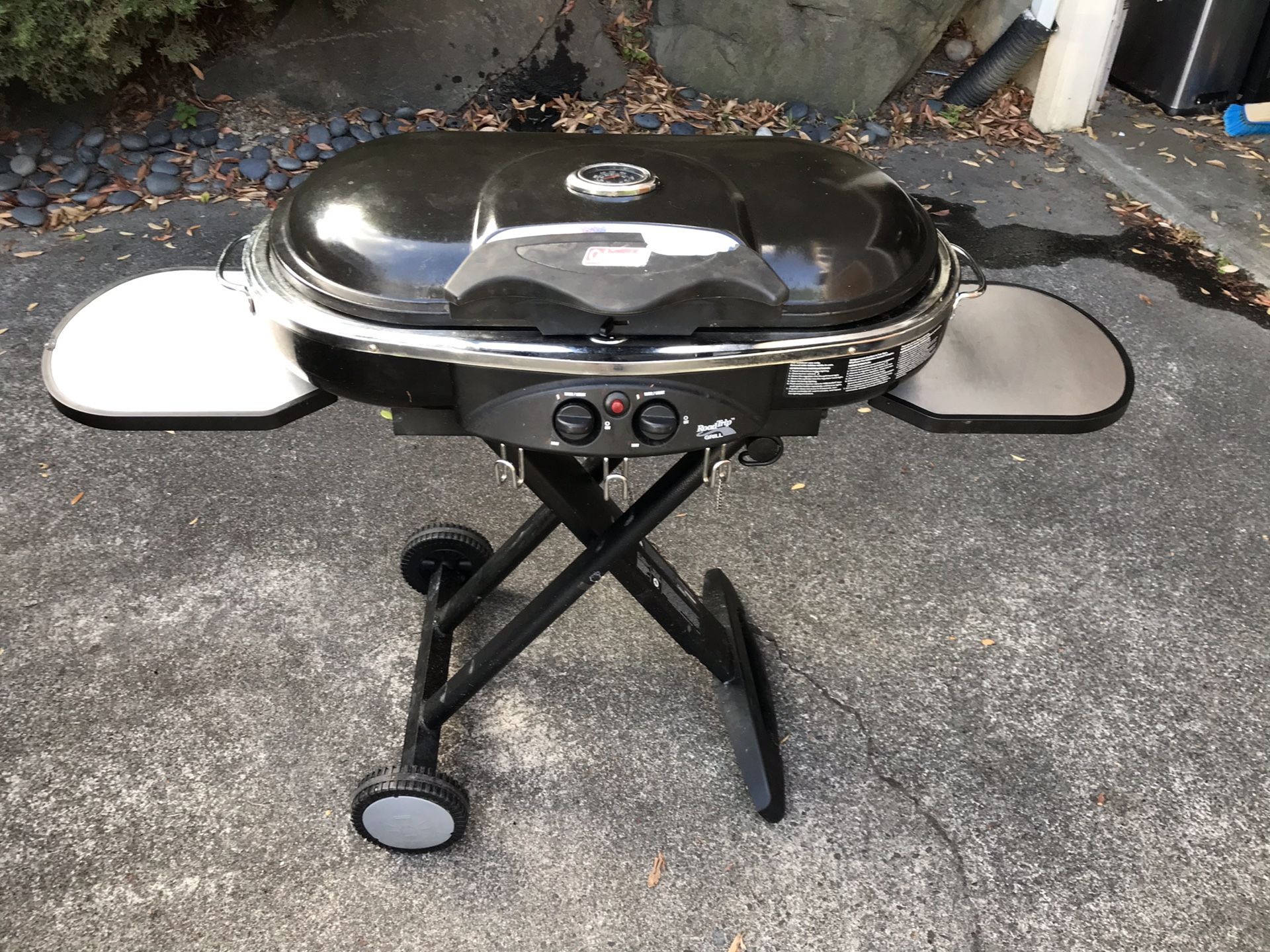 Coleman LXE roadtrip grill with transport case and extra burner surfaces.