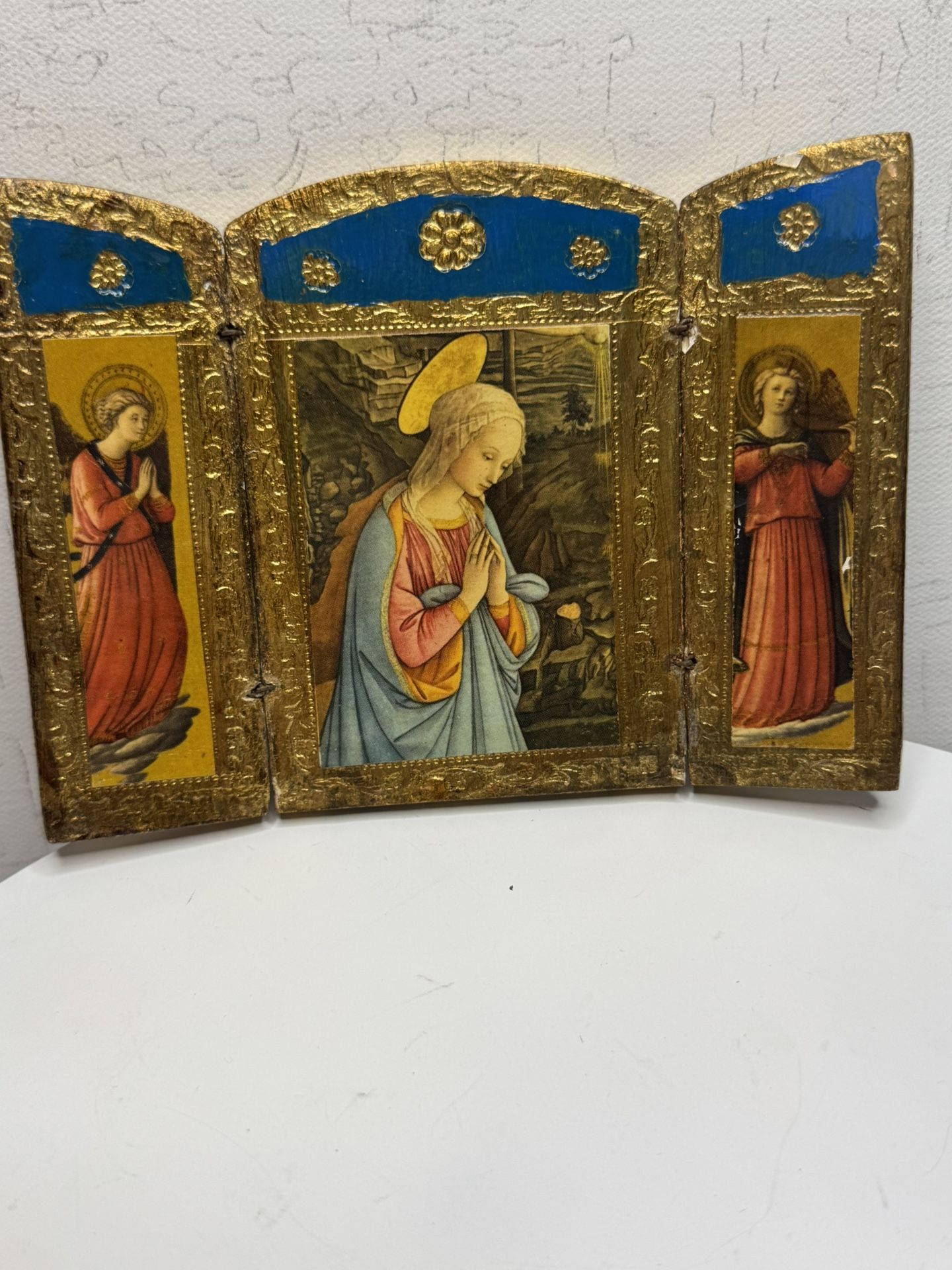 A Florentine triptych, the image on which is based on a painting by the Italian Renaissance artist Fra Filippo Lippi.  Folding icon (triptych) made of