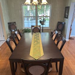 Large formal dining table with 8 chairs