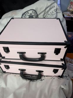 Pink and black decorative suit cases