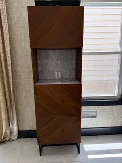 CB2 This item is the CB2 Suspend White Marble and Wood Bar Cabinet.
