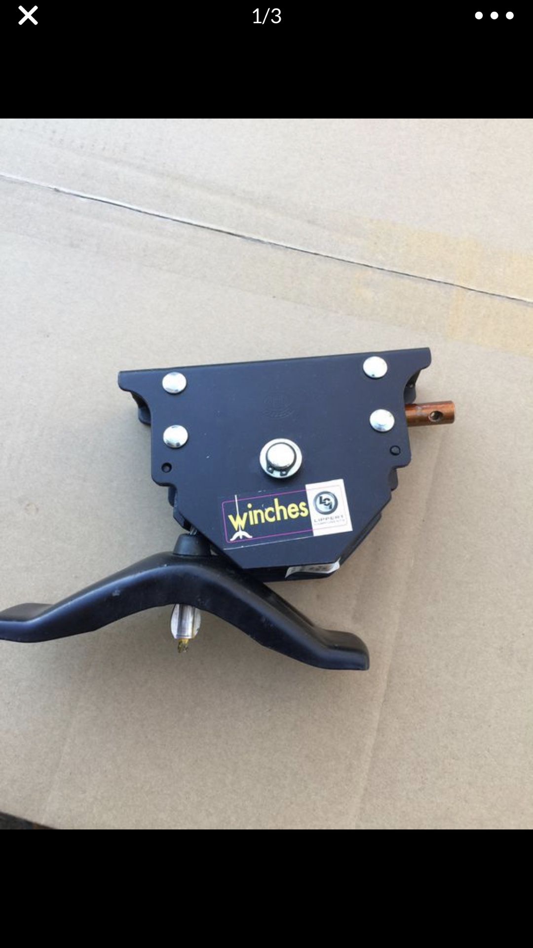 Lippert spare tire winch with offset cable