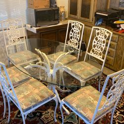 Wrought Iron Dinette With Six Wrought Iron Chairs In Good Shape. Glass Has Small Chip On. It Comes With Tablecloth.
