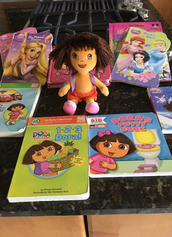 9 books 1 doll Dora good condition