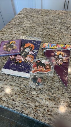 Harry Potter birthday decorations, a flag, a cake, topper, cupcake, toppers, napkins, and table cover