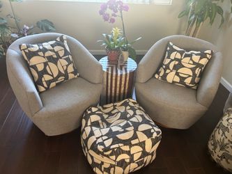Pair of grey swivel barrel chairs