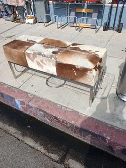 cowhide and polished steel bench.