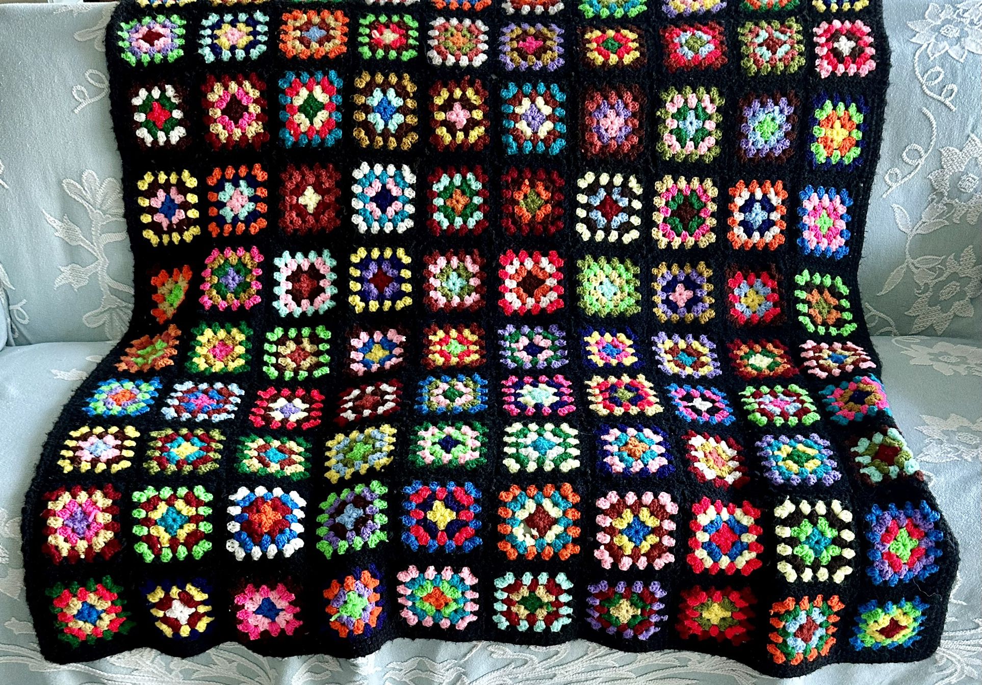 Vintage handmade crocheted groovy granny square afghan/blanket.  Nice large size at 79”x 54”. This one has ALL the colors. Background is black. 