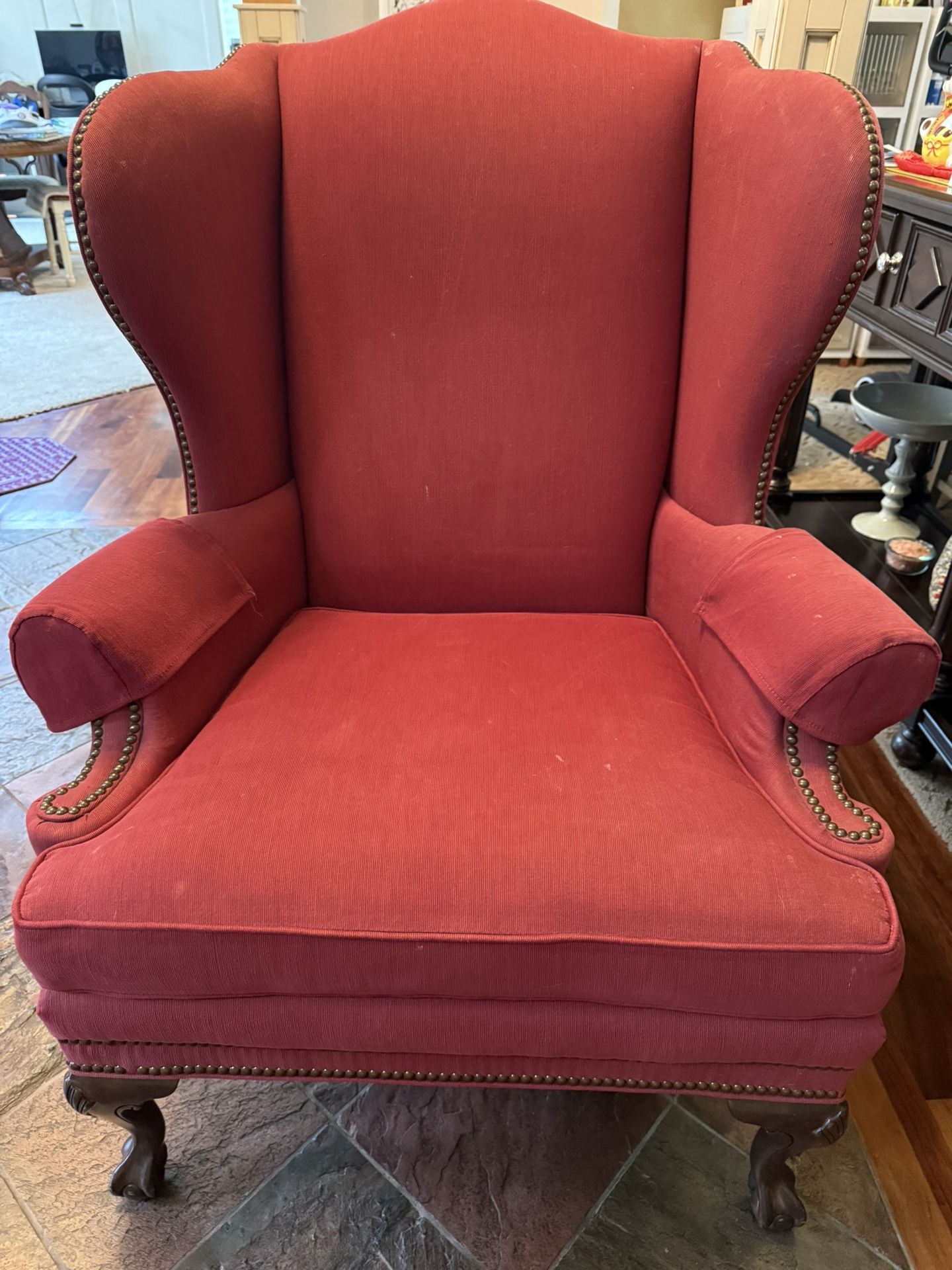Upholstered wingback chair with nailhead trim