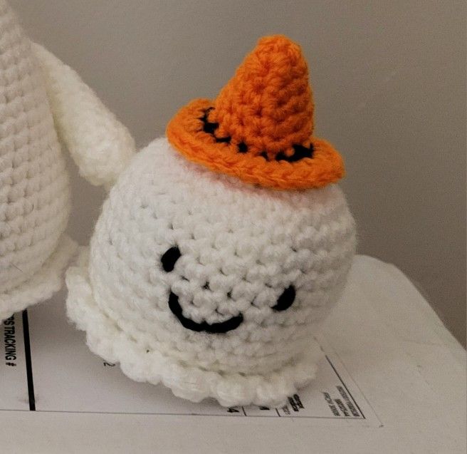 Hand crocheted cute and fun little ghosts with orange, green or purple hats. $4