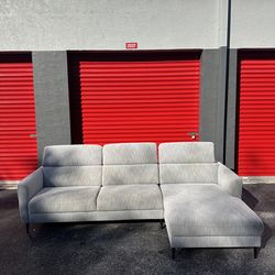 MODERN GREY FABRIC SECTIONAL COUCH/ 2 PIECES/ HEADRESTS ARE ADJUSTABLE/ IN GOOD CONDITION/ DELIVERY NEGOTIABLE