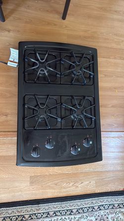 Black Whirlpool 30-Inch Gas Cooktop with four sealed burners