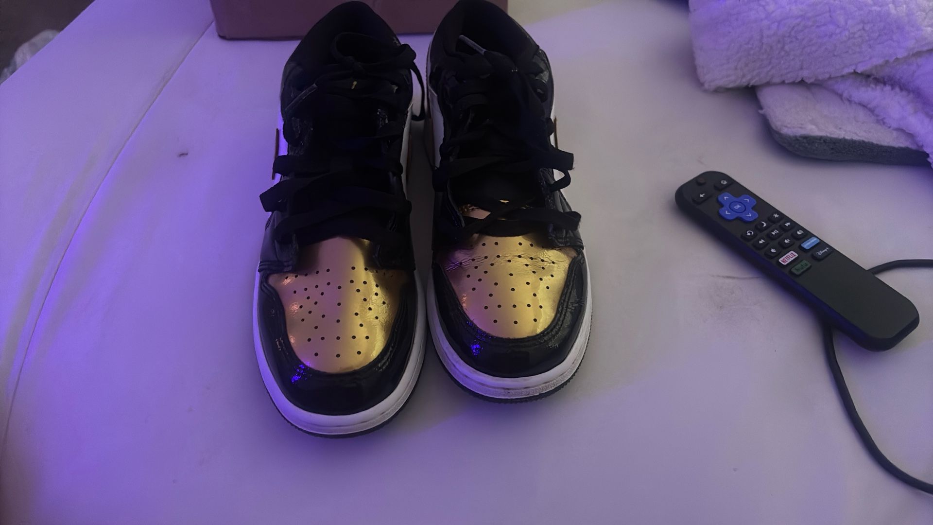Air Jordan 1 Low Gold Toe sneakers.