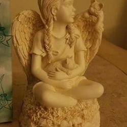 Little girl and cat angel music box plays up where they belong