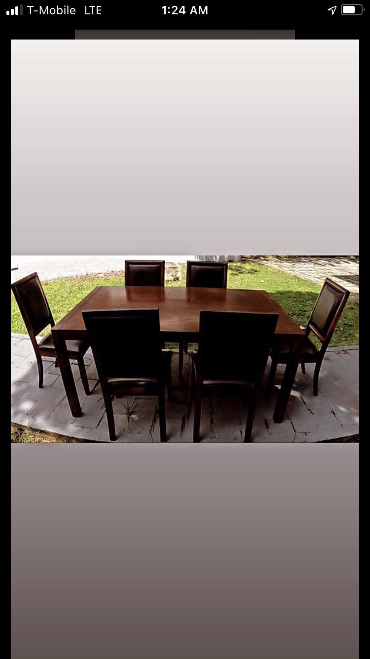 Beautiful wood dining table with 6 leather seat chairs in good condition.....will deliver