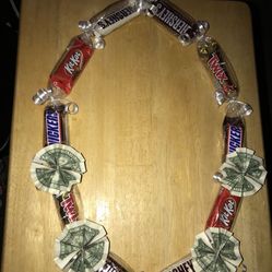 Candy/Chocolate Lei with five dollars. 