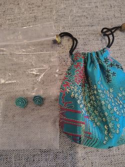 A pair of turquoise stones. You can make them into a pair of earrings.