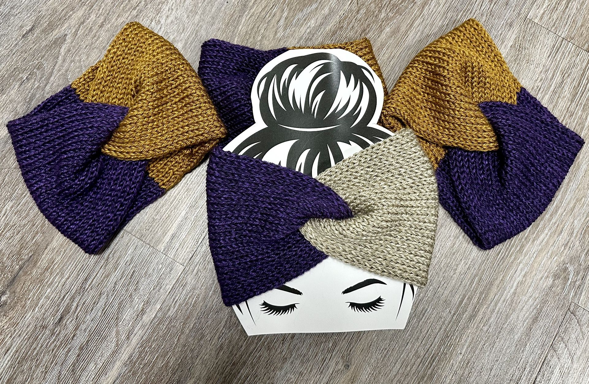 Knitted purple and gold headband.