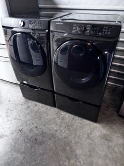 Black stainless Samsung - 5.0 Cu. Ft. High-Efficiency Front Load Washer and front load Samsung dryer 7.5 cu.ft  with pedestals. working great.extra fo