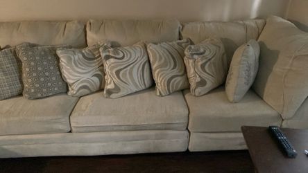 Sofa it’s beige with pretty decorated pillows
