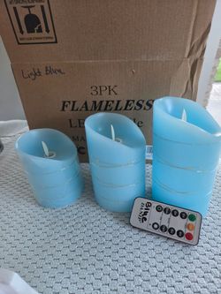Three pc w remote flameless candles with lights on outside. Battery operated. Like new