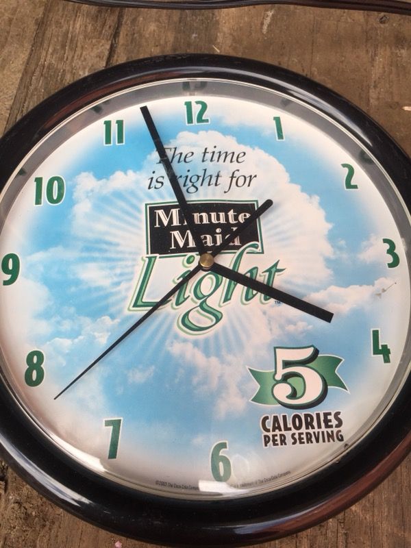 round black Minute Maid analog wall clock