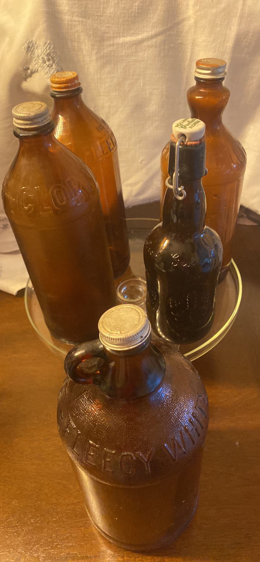 4 Vintage Amber Fleecy White And Clorox Bottles And 1 Beer Bottle
