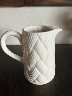 white ceramic or stoneware pitcher featuring a textured, woven herringbone pattern