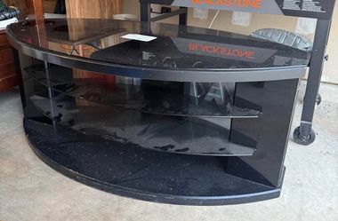 BLACK WOOD TABLE; oval with glass shelves
