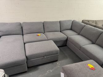 Large grey sofa couch with ottoman storage