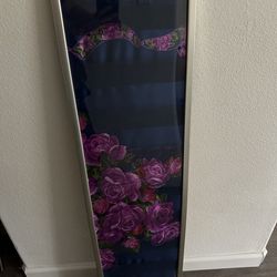 Silver frame with gold hanging accessory and fabric art