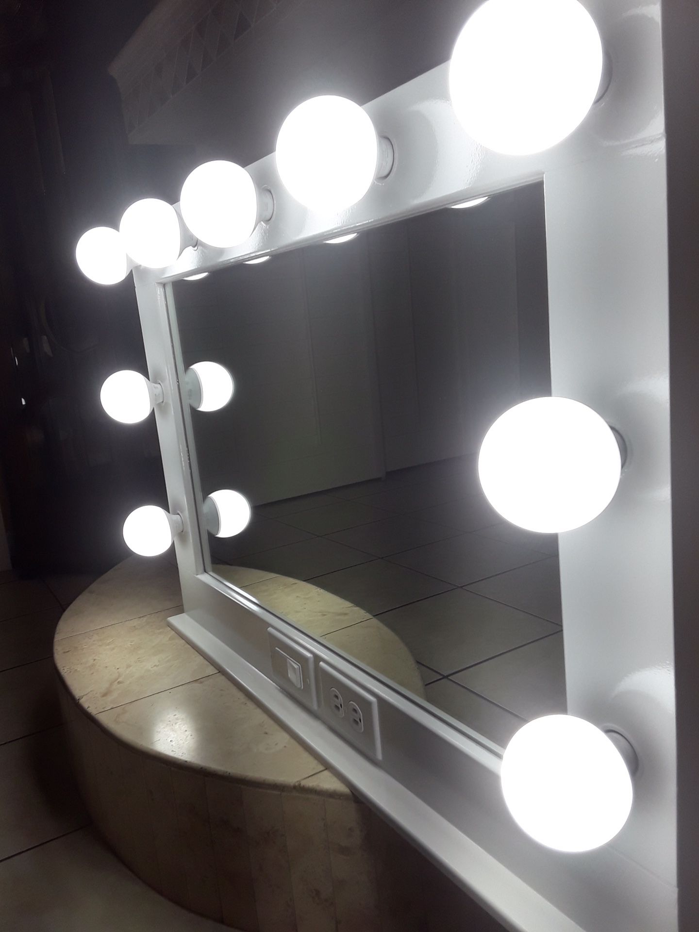 Vanity mirror with electric outlet