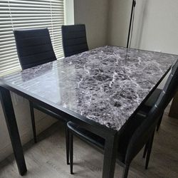 Marble-Top Dining Table with 4 black chairs