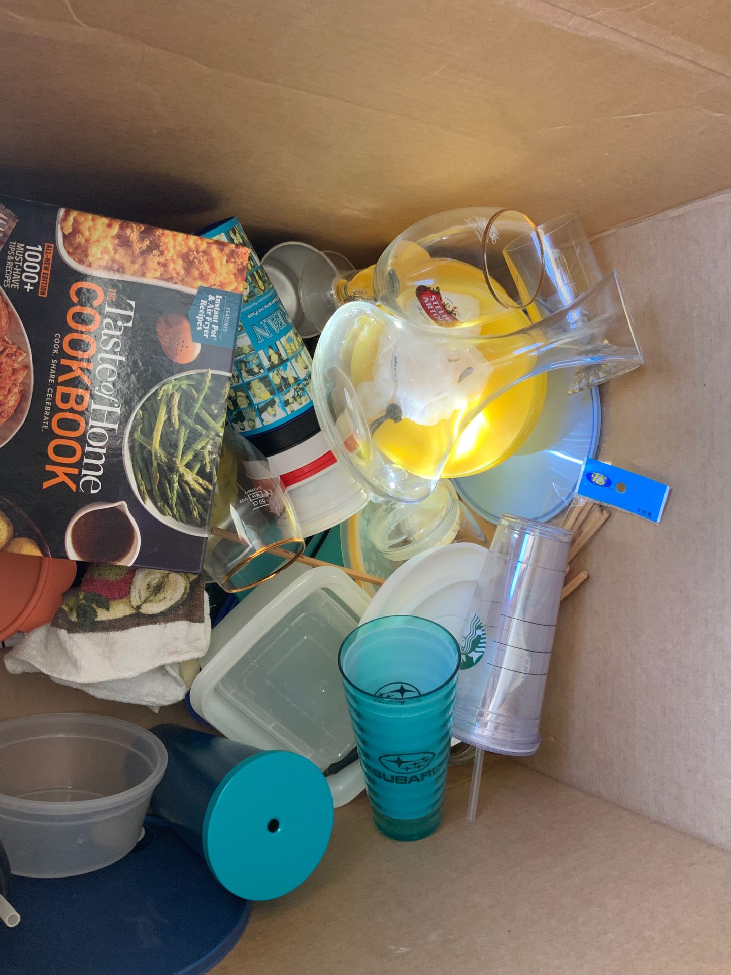 Large box of kitchen items including Starbucks glasses and Tupperware