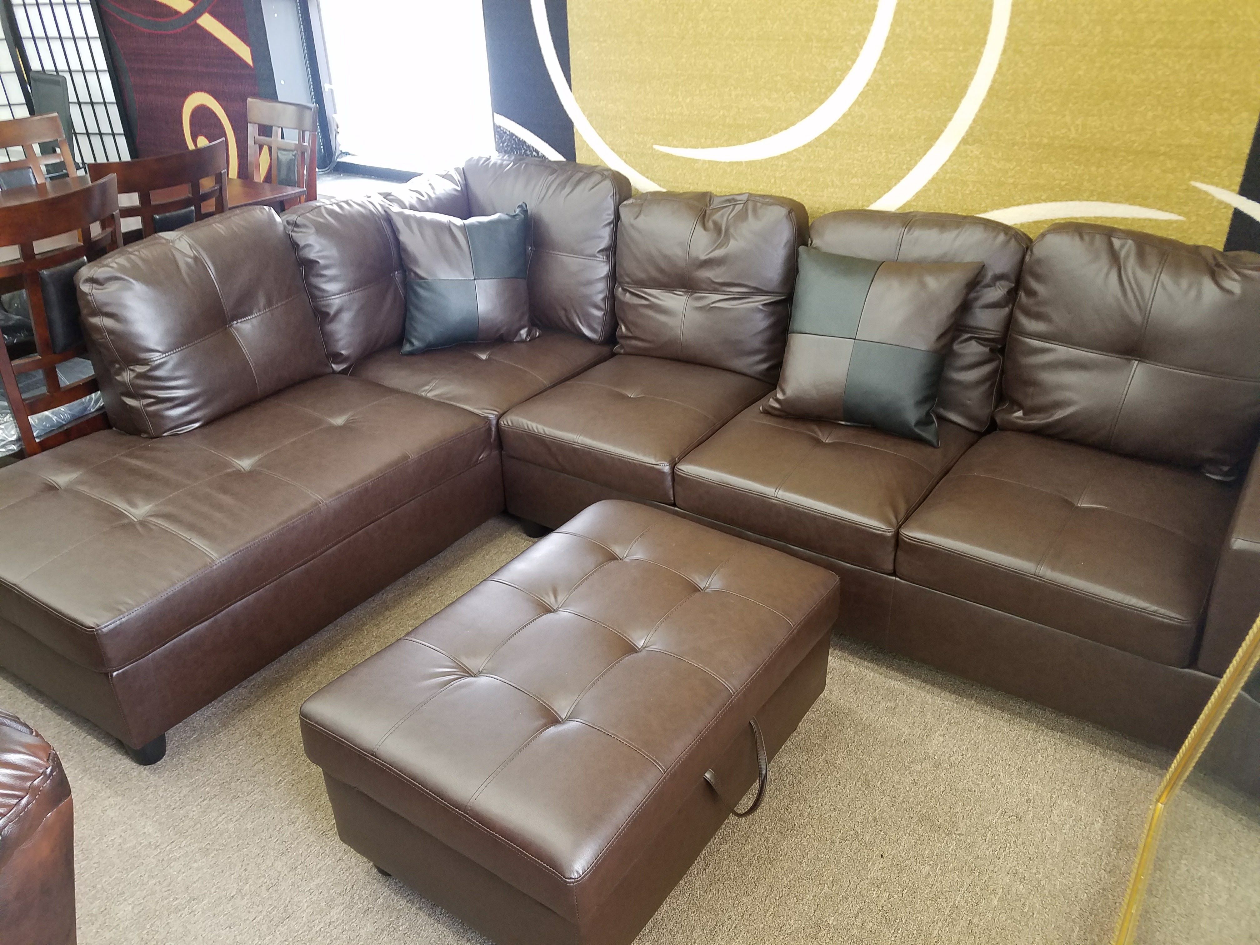 New in box espresso sectional with pillows and storage ottoman