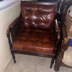 vintage tufted leather armchair with cane sides and turned wood legs From The 1950s /1980s