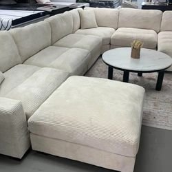 7Pc Beige corduroy sectional sofa with ottoman